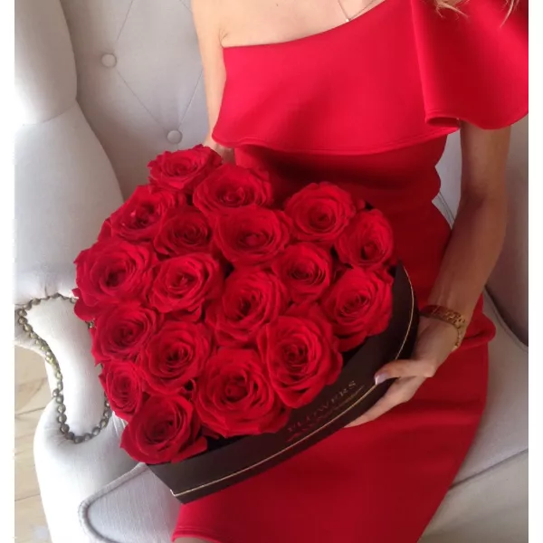 Floral arrangement in a heart-shaped box with roses